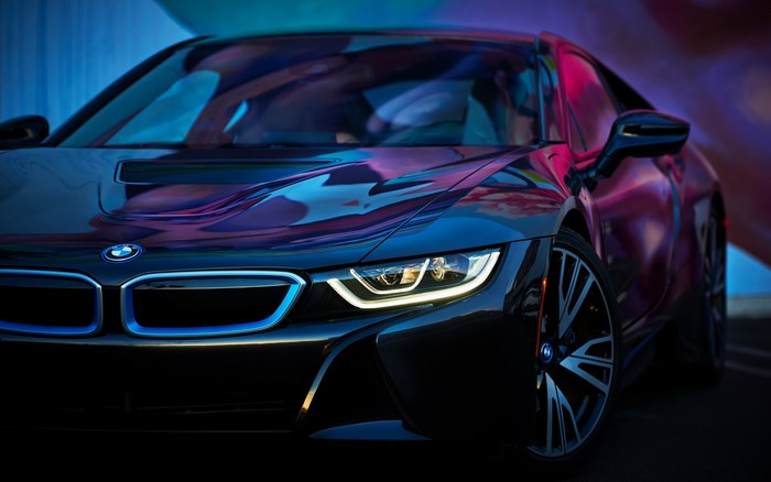 Black BMW i8 with blue accents and colorful reflections