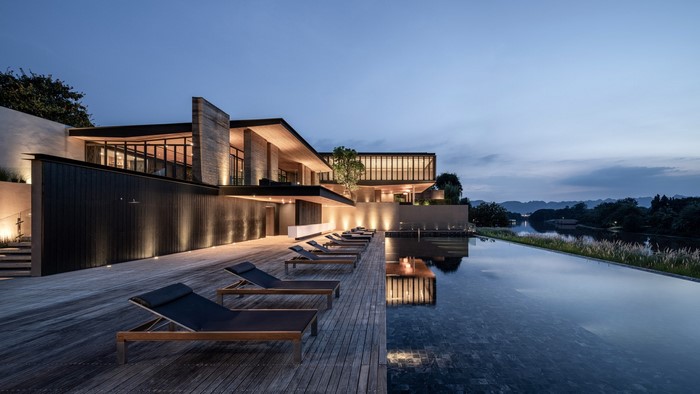Modern house with swimming pool at dusk