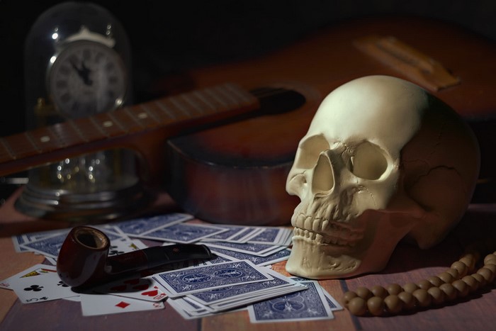 Still life with skull, guitar, pipe, and clock
