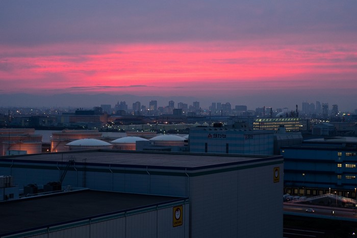 Industrial skyline at dusk with pink clouds