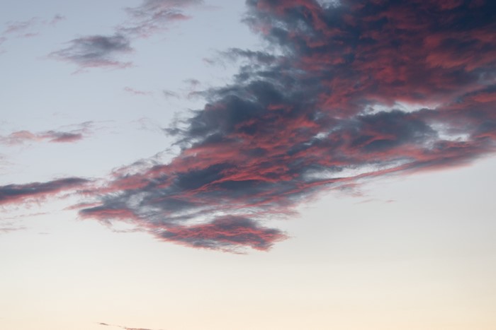 Pink and gray clouds in the sky at sunset
