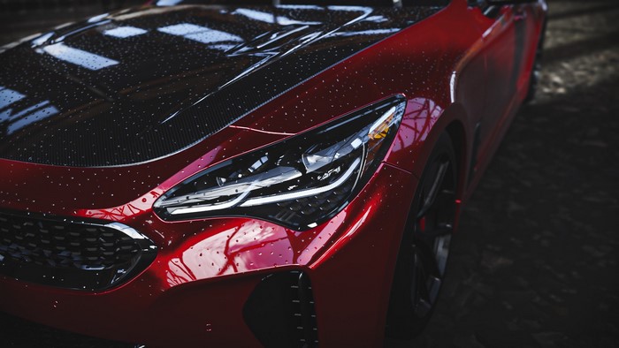 Red Kia Stinger GT with water droplets