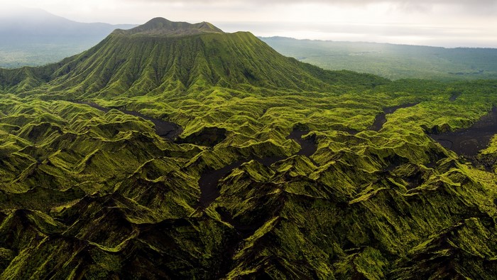 Green volcanic landscape with a dormant volcano