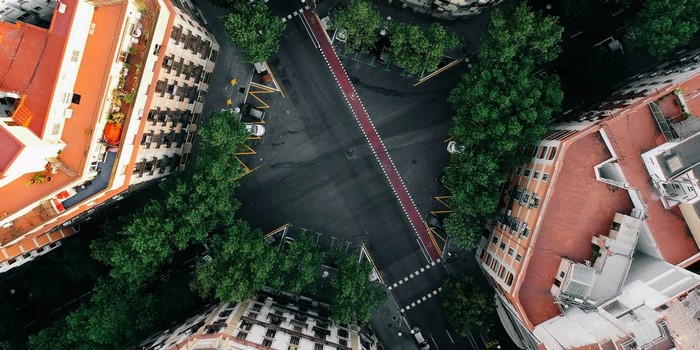 Aerial view of a city intersection with buildings and trees