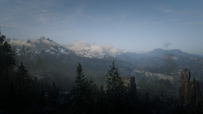 Snowy mountains and forest in Red Dead Redemption 2