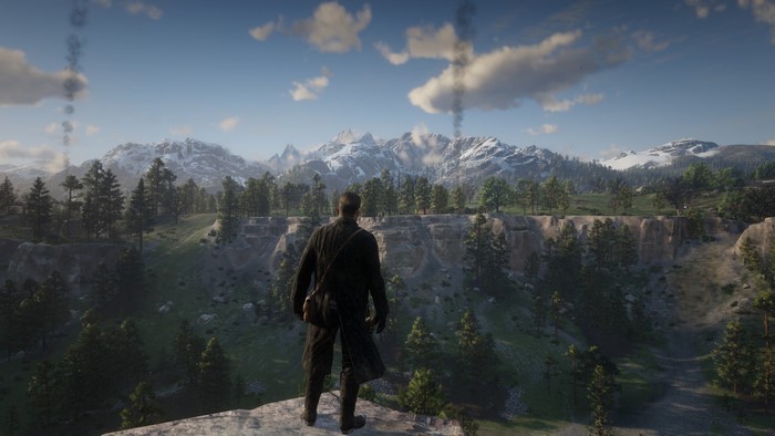 Man overlooking snowy mountains in Red Dead Redemption 2