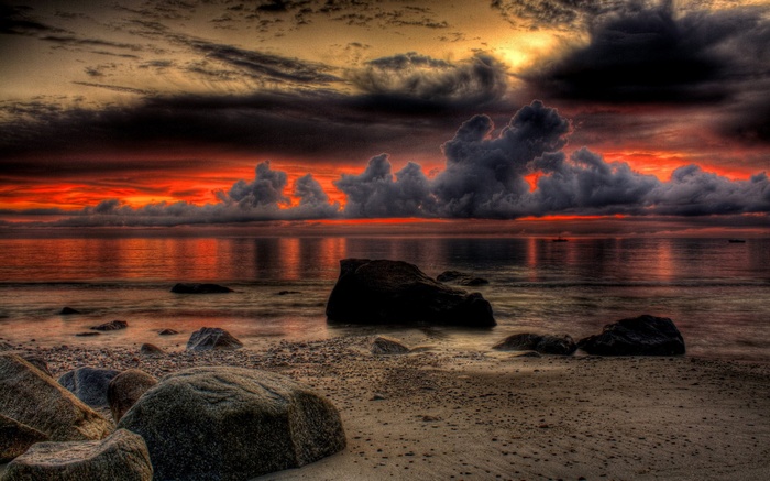 Dramatic sunset over a rocky beach and ocean