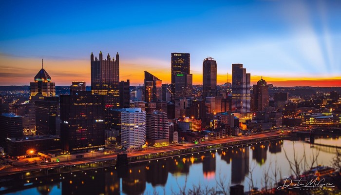 Pittsburgh skyline at dusk with river reflection
