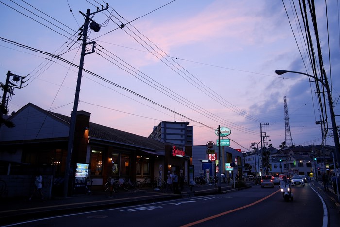Street scene at dusk with power lines and buildings