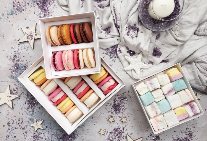 Boxes of colorful macarons and marshmallows
