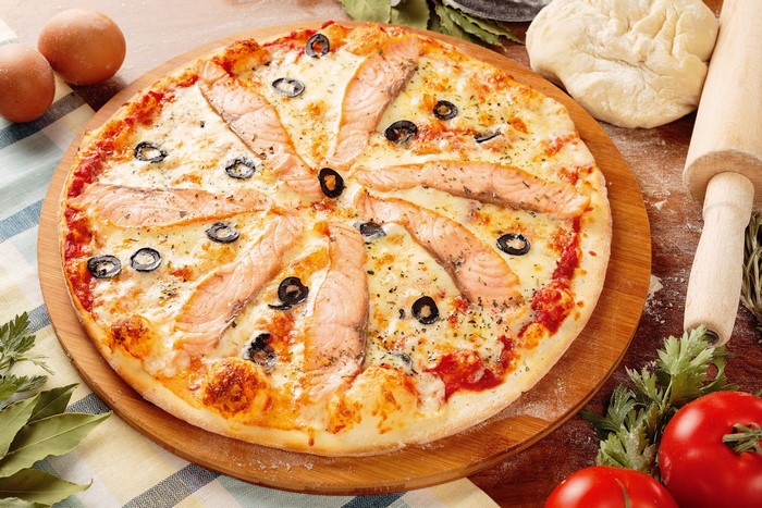 Salmon and olive pizza with fresh ingredients
