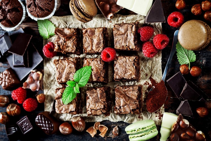 Chocolate brownies with raspberries and macarons
