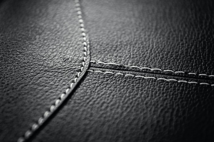 Black leather texture with white stitching