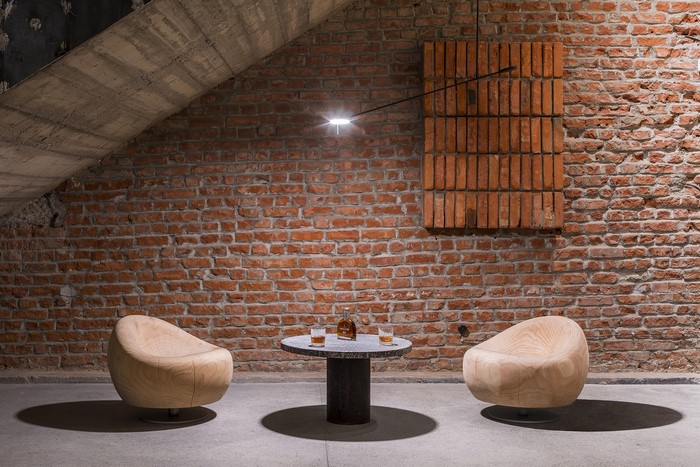 Interior with brick wall, chairs, and table