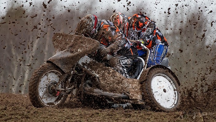 Motorcycle sidecar racing through mud
