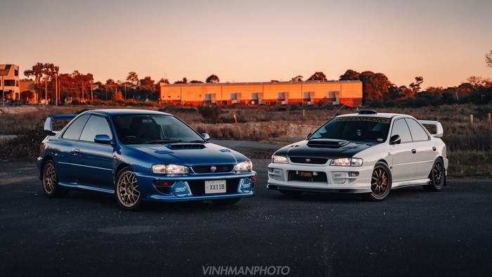 Two Subaru Impreza WRX STi cars, one blue, one white