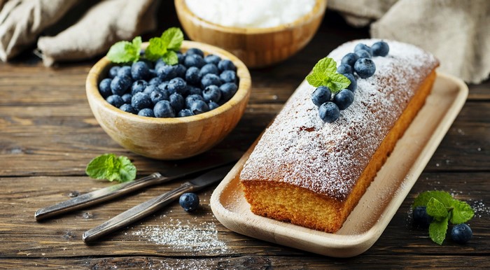 Blueberry loaf cake with powdered sugar and mint