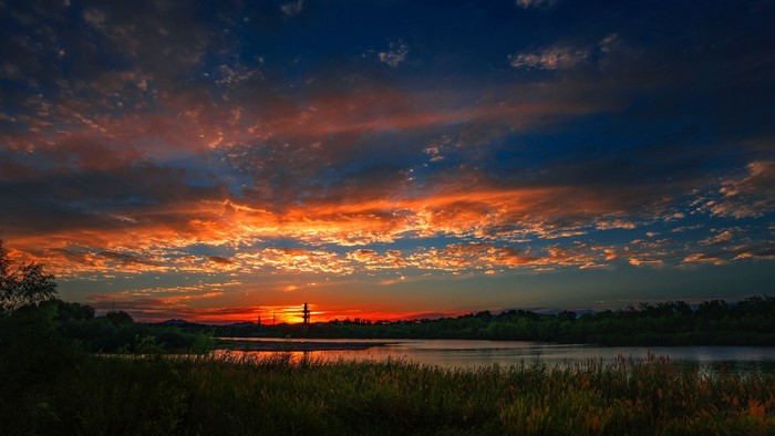 Sunset over a river with dramatic clouds