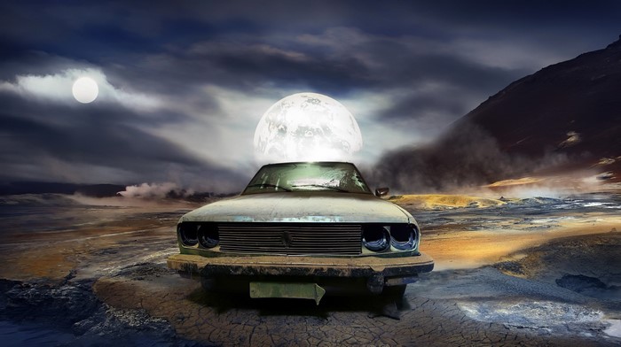 Car with moon on top in desolate landscape