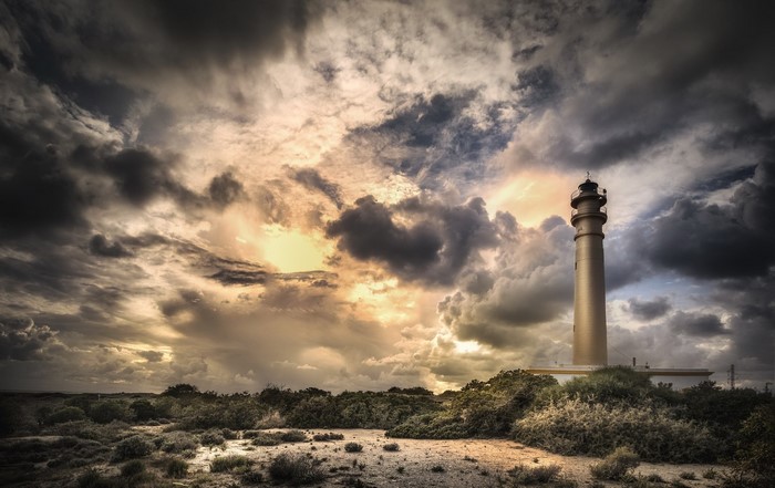 Lighthouse in Andalusia, Spain under dramatic sky