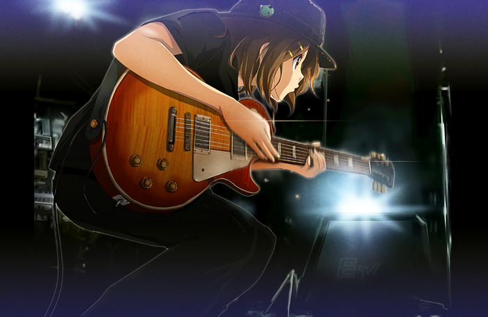 Hirasawa Yui playing an electric guitar on stage