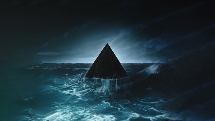 Black pyramid in stormy ocean waves