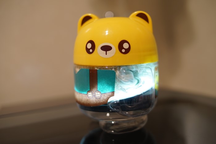 Yellow bear-shaped bottle with light