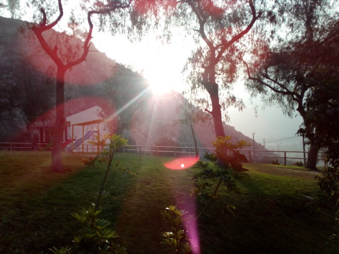 Park with playground and mountain at sunrise