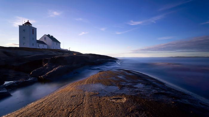 Lighthouse on rocky coast in Norway