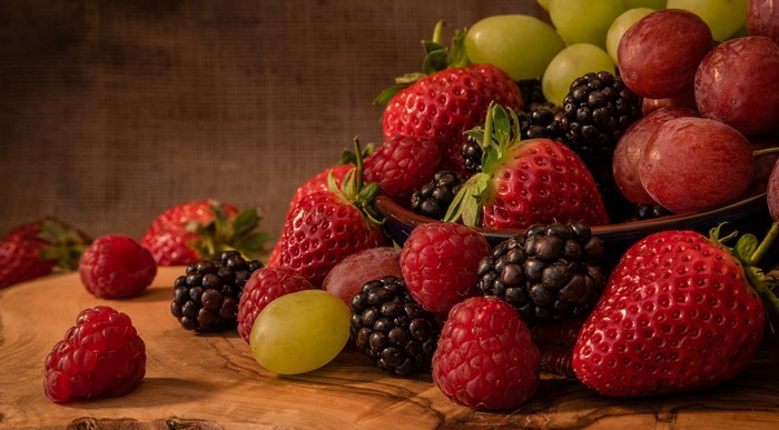 Assortment of fresh berries and grapes in a bowl
