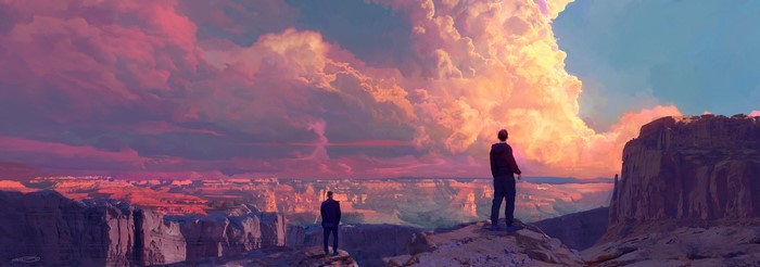 Two people on a cliff overlooking a canyon at sunset