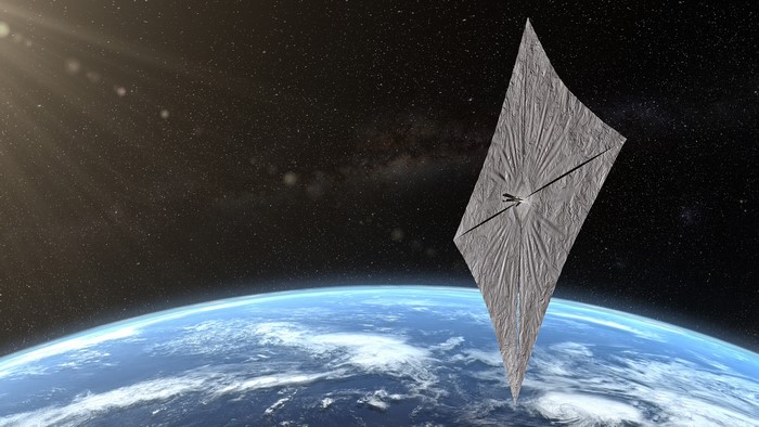 Solar sail spacecraft above Earth with stars and lens flare