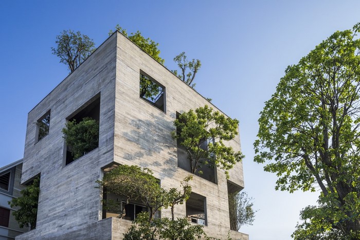 Modern concrete building with trees and windows