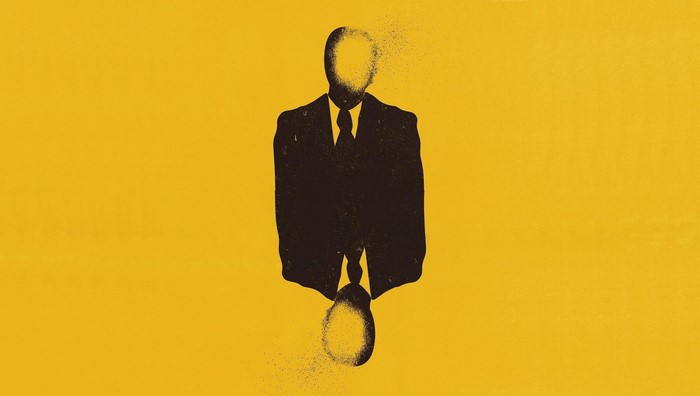Silhouette of a man in a suit dissolving into particles
