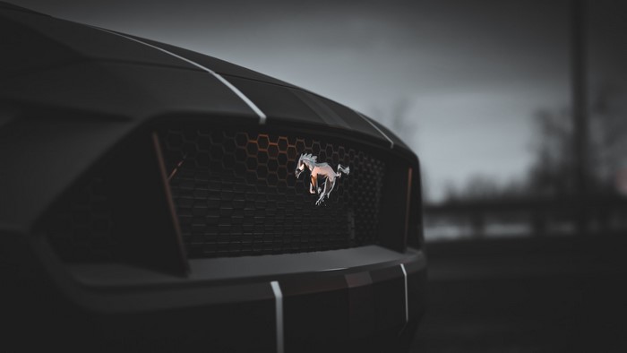Ford Mustang car emblem on a black grille