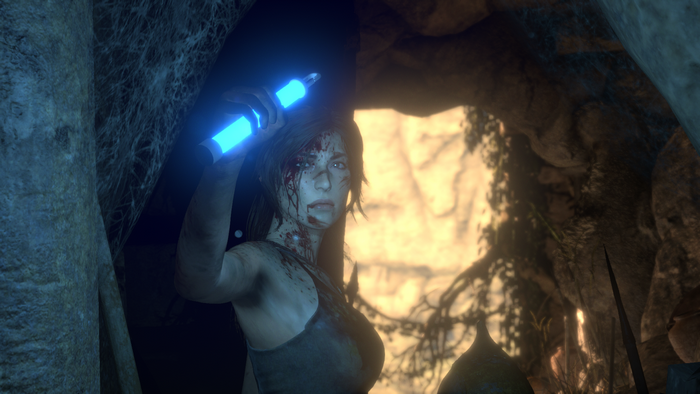 Lara Croft from Rise of the Tomb Raider holding a blue light