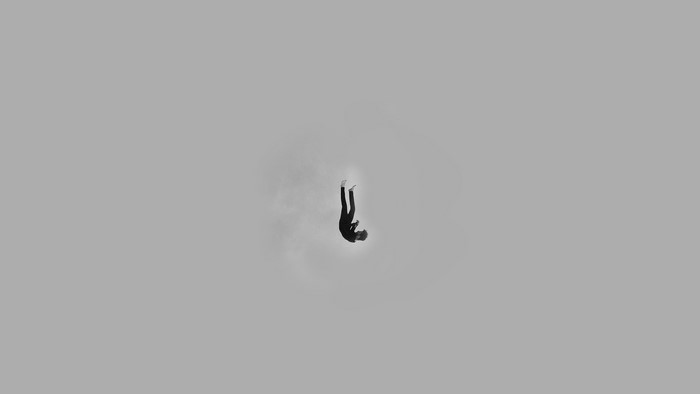 Person falling in a minimalist grey sky