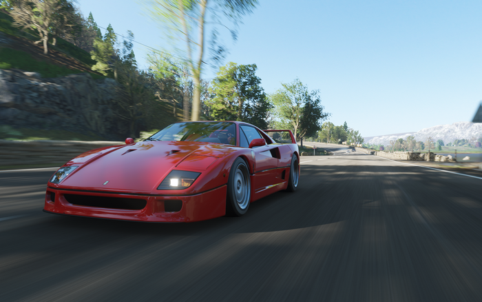 Red Ferrari F40 driving on a road in Forza Horizon 4