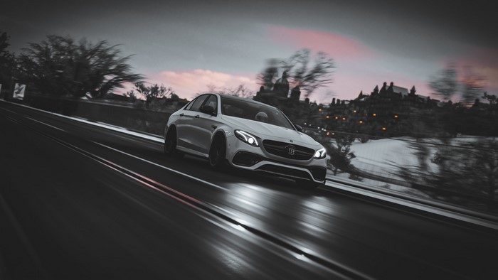 White Brabus 800 Mercedes AMG E63S driving on a road