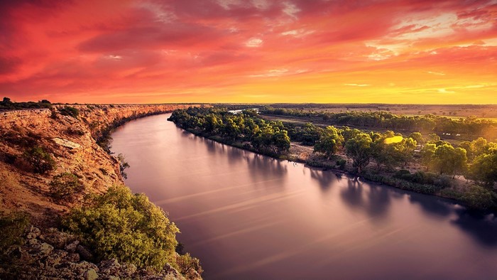 River canyon at sunset with dramatic sky