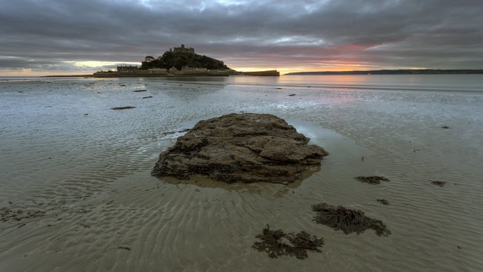 St Michael's Mount at sunset on a sandy shore