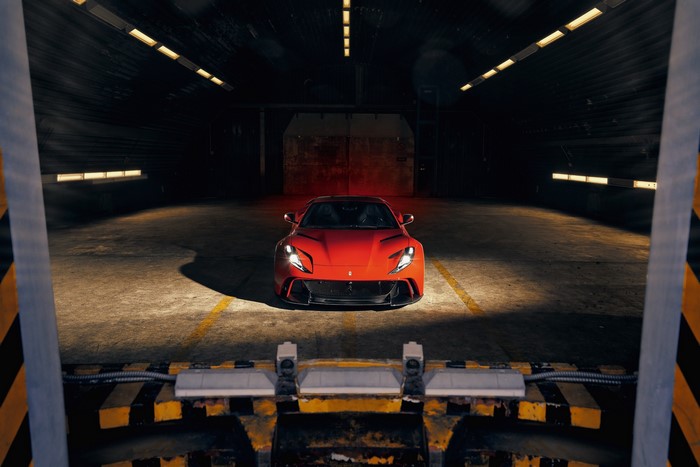 Red Ferrari 812 Superfast parked in a dark garage