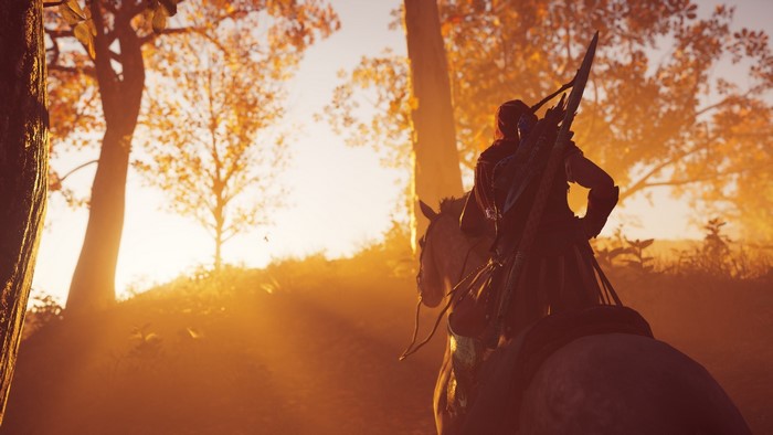 Kassandra on horseback in a forest at sunrise