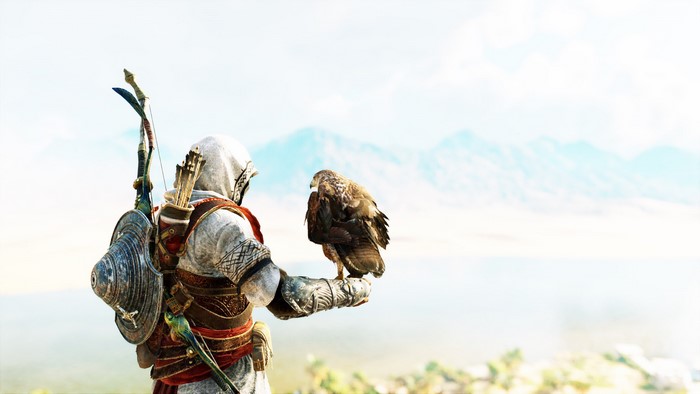 Bayek holding a bird in Assassin's Creed Origins