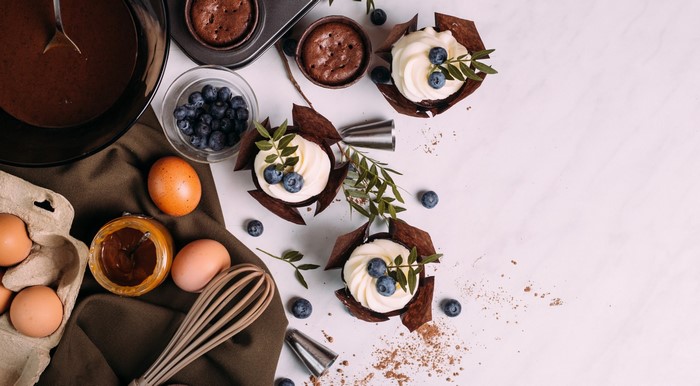 Cupcakes with blueberries and baking ingredients