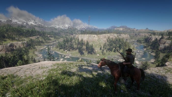 Cowboy on a horse overlooking a river valley in Red Dead Redemption 2