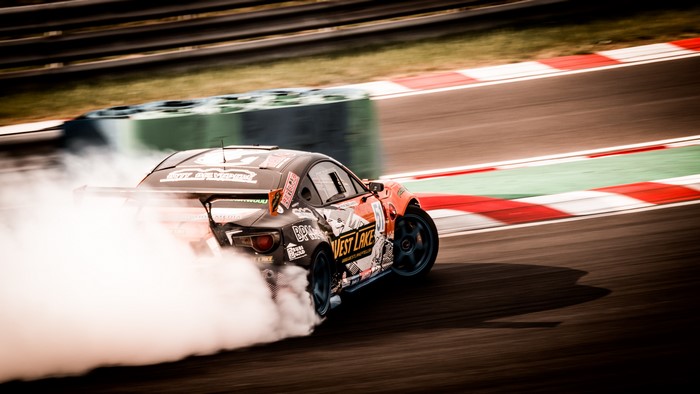 4K drift car on a racetrack with smoke