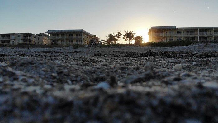 Worm's eye view of beach buildings at sunset