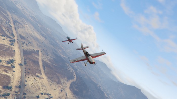 Two airplanes flying over a desert landscape in Grand Theft Auto V