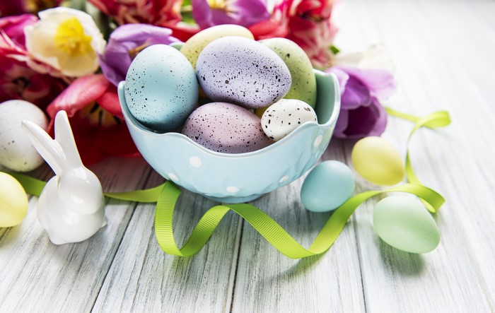 Easter eggs and tulips on a wooden table